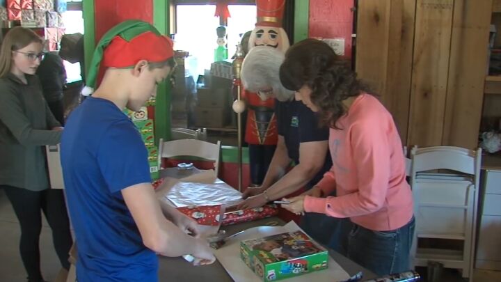 Volunteers wrap presents for Talon Falls Adventure Park event